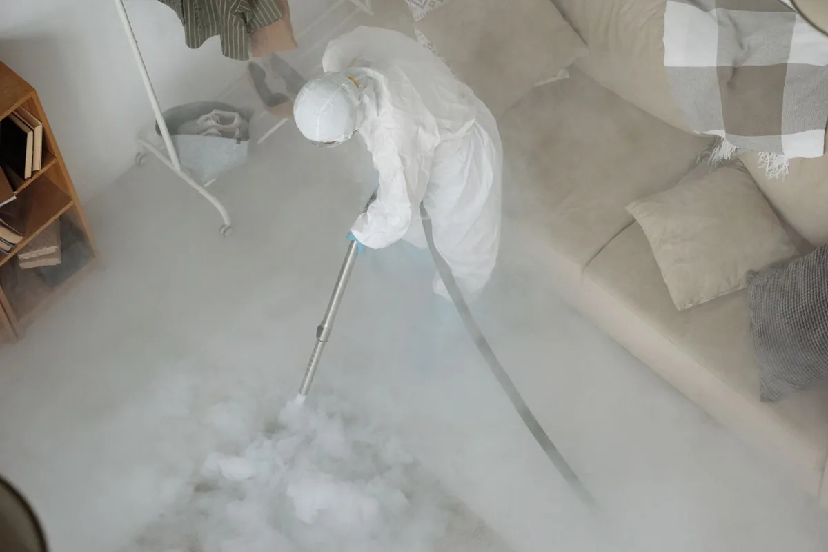 Biohazard cleanup technician in protective equipment, West Liberty, IA